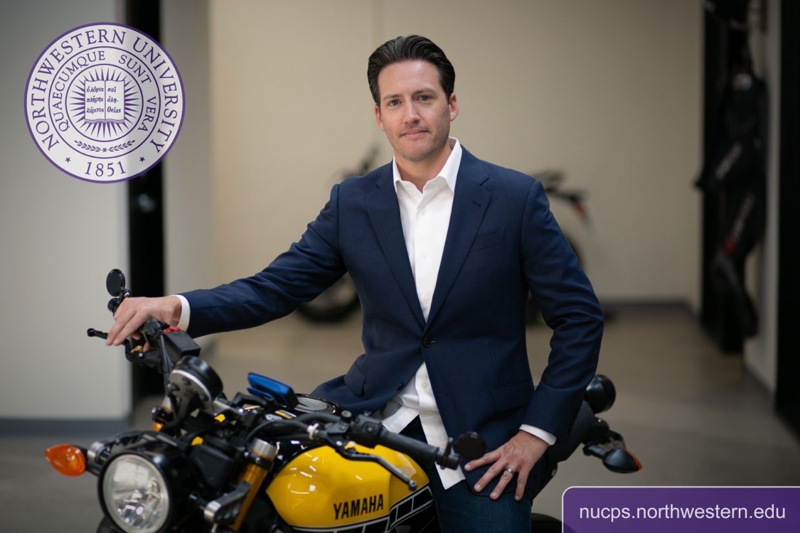 Louis Peck sitting on motorcycle.