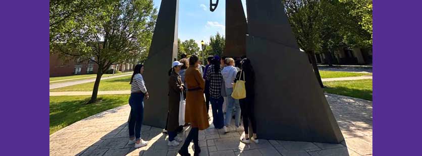 students viewing outdoor sculpture